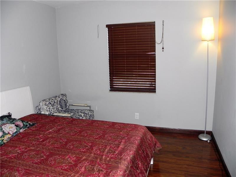 9650 Colorado Court Boca Raton, FL 33434 - Photo 8 of 14 a bedroom with a bed and a window