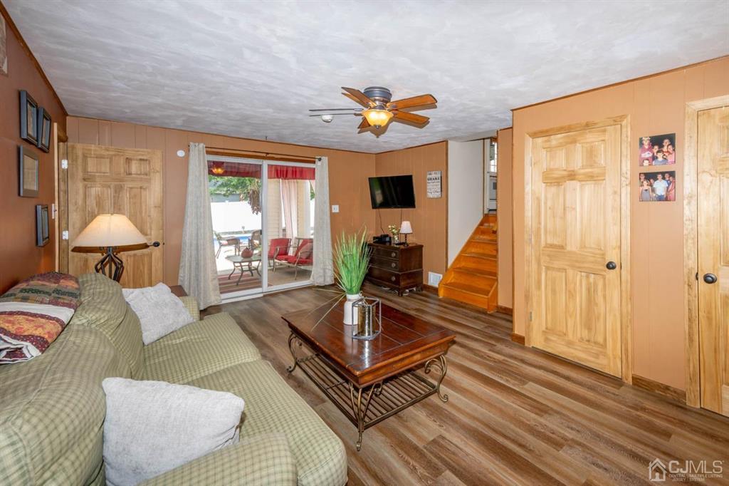 16 Hansen Road Old Bridge, NJ 08857 - Photo 12 of 32 a living room with furniture a flat screen tv and a large window