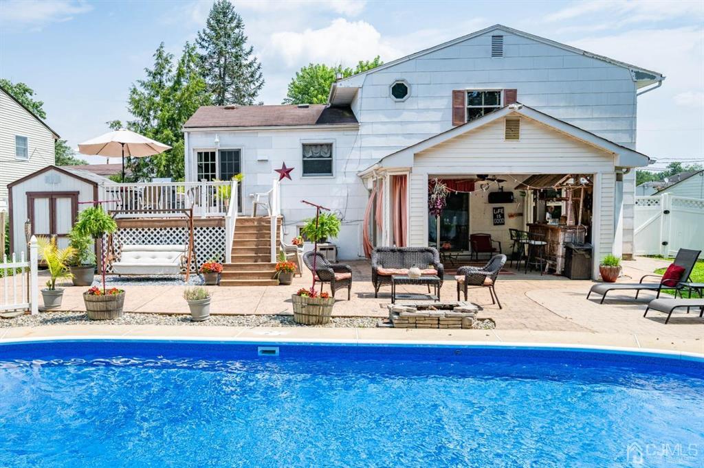 16 Hansen Road Old Bridge, NJ 08857 - Photo 25 of 32 a view of house with swimming pool outdoor seating and yard