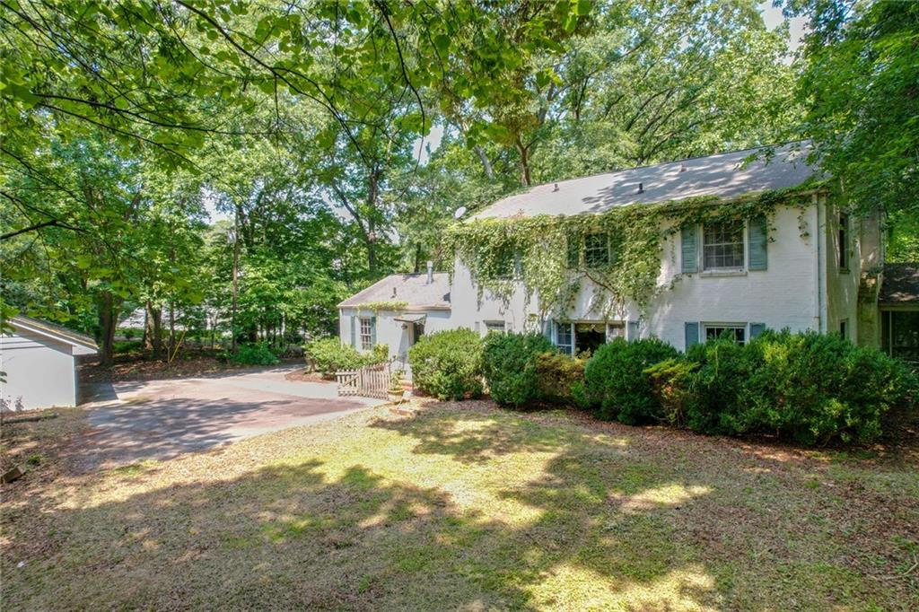 1700 West Paces Ferry Road Northwest Atlanta, GA 30327 - Photo 6 of 6 a backyard of a house with plants and trees with wooden fence