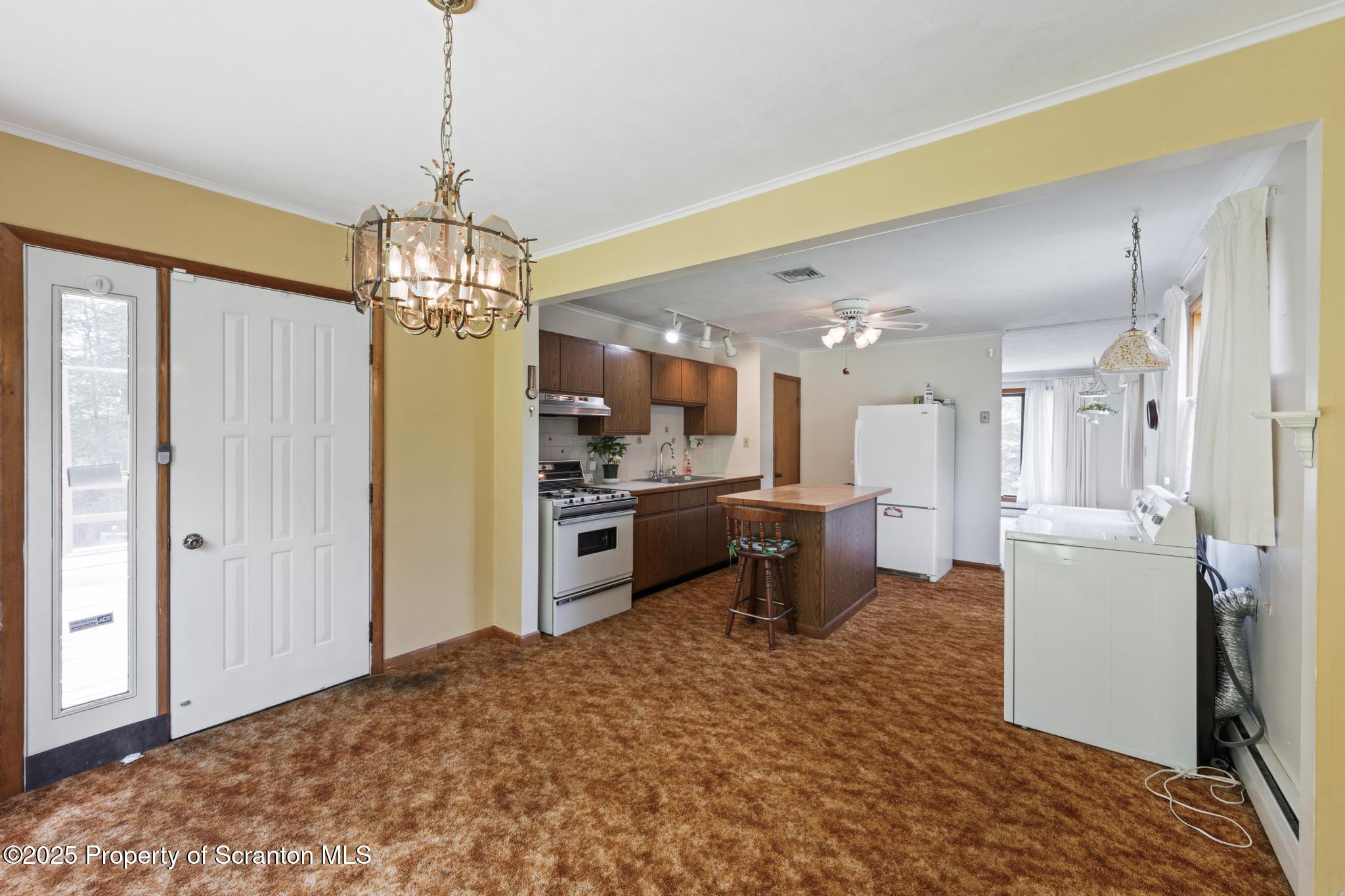 378 Gravel Pond Road Clarks Summit, PA 18411 - Photo 14 of 30 a open kitchen with stainless steel appliances granite countertop a refrigerator and a stove top oven
