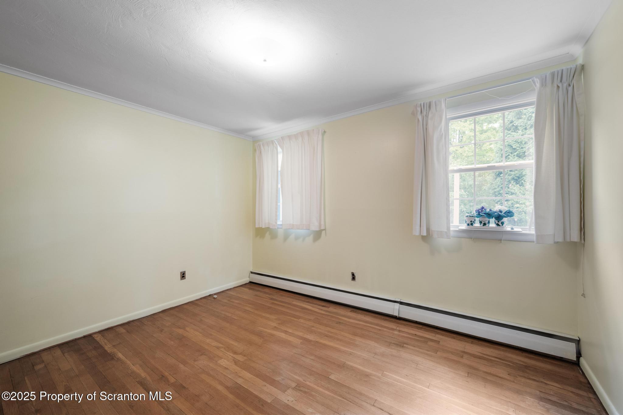378 Gravel Pond Road Clarks Summit, PA 18411 - Photo 16 of 30 an empty room with wooden floor and windows