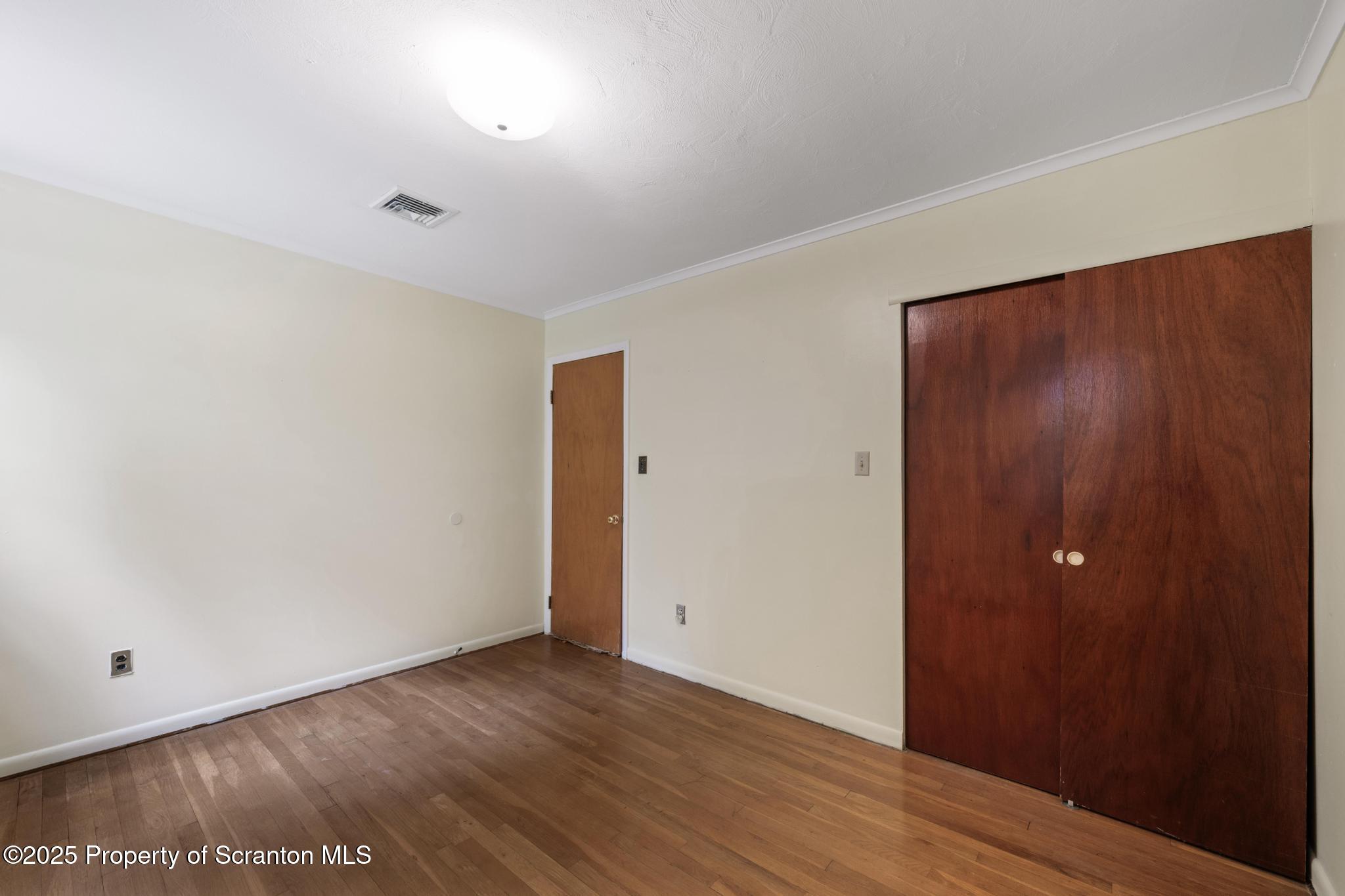 378 Gravel Pond Road Clarks Summit, PA 18411 - Photo 17 of 30 an empty room with wooden floor and windows