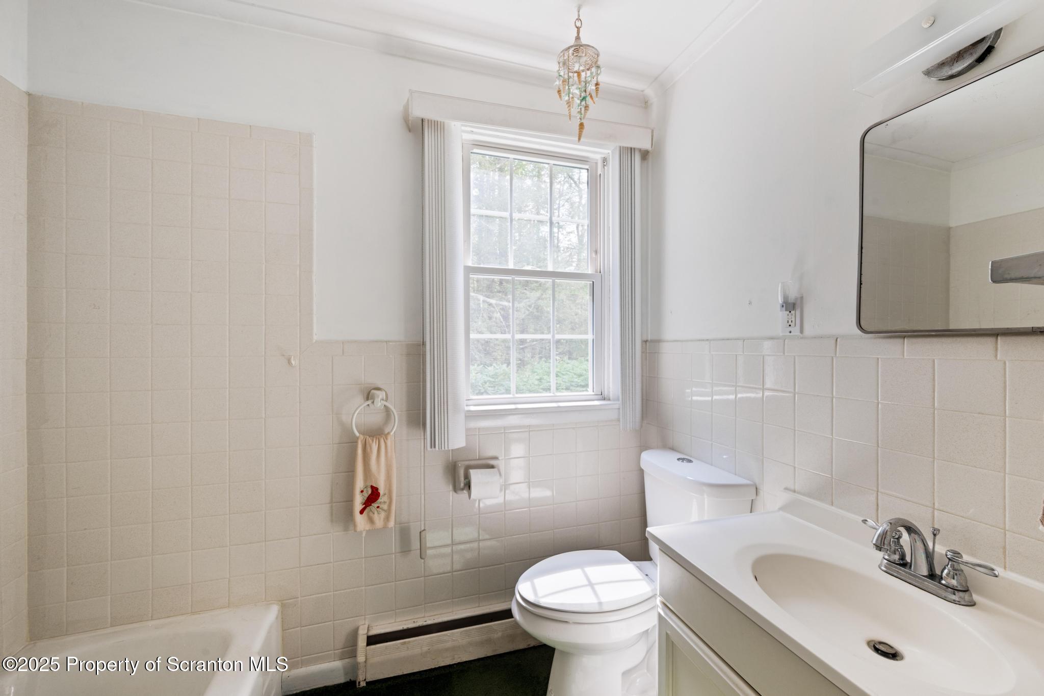 378 Gravel Pond Road Clarks Summit, PA 18411 - Photo 18 of 30 a bathroom with a sink toilet and a mirror