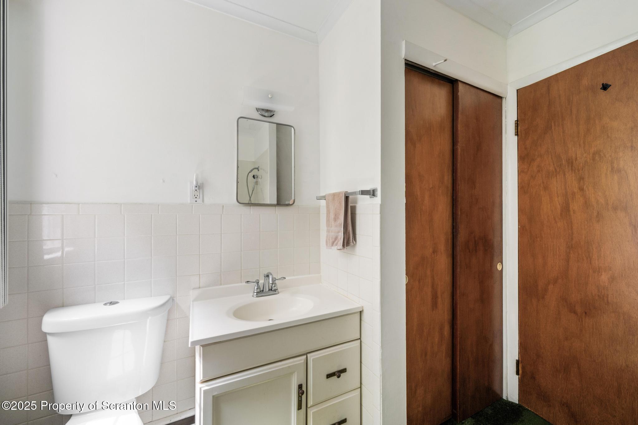 378 Gravel Pond Road Clarks Summit, PA 18411 - Photo 19 of 30 a bathroom with a sink a toilet and mirror