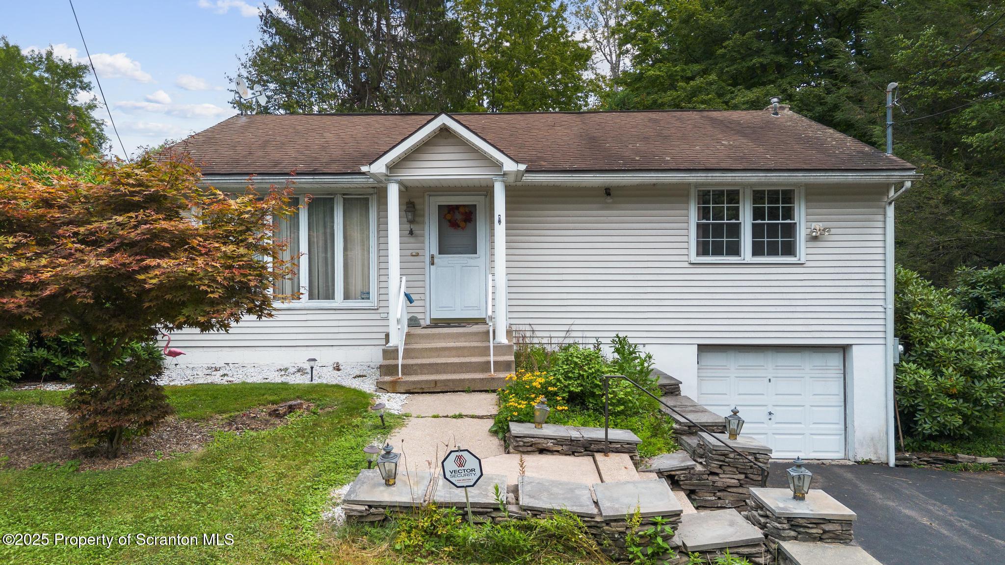 378 Gravel Pond Road Clarks Summit, PA 18411 - Photo 2 of 30 a front view of a house with garden
