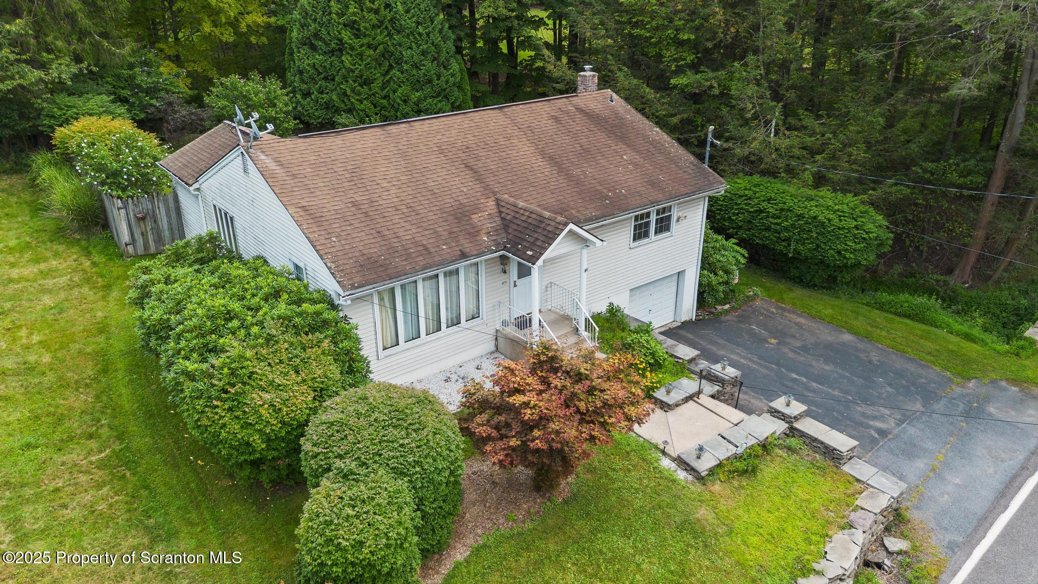 378 Gravel Pond Road Clarks Summit, PA 18411 - Photo 3 of 30 a aerial view of a house with a yard plants and large tree