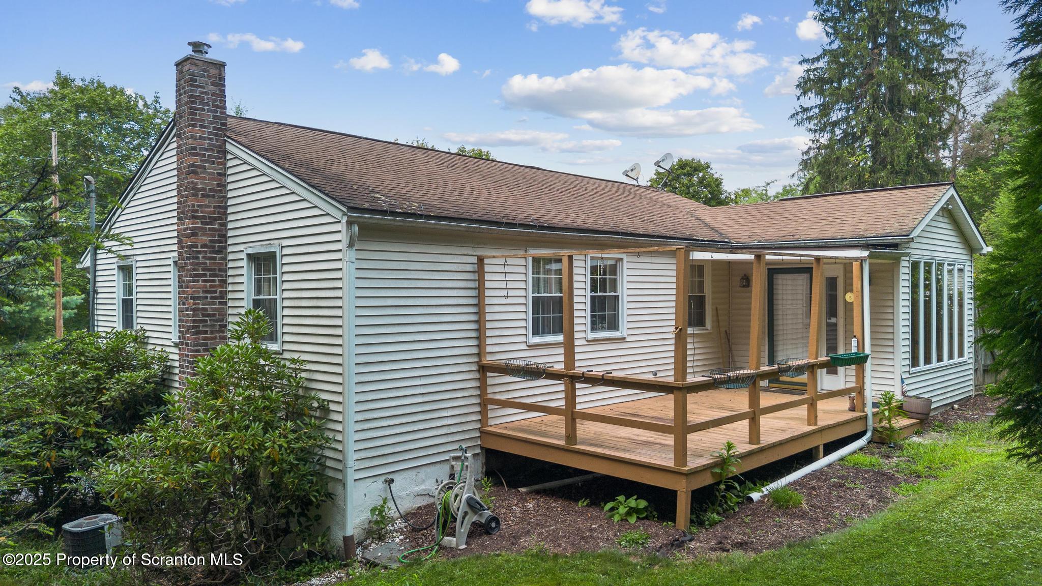 378 Gravel Pond Road Clarks Summit, PA 18411 - Photo 8 of 30 a backyard of a house with a garden and deck