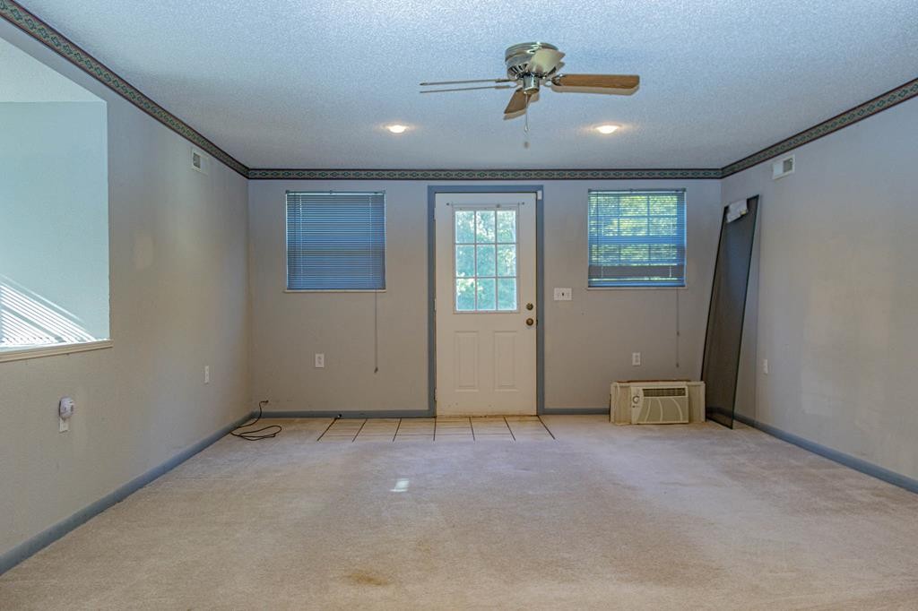 3520 Blue Springs Road Sweetwater, TN 37874 - Photo 25 of 49 an empty room with ceiling fan and windows