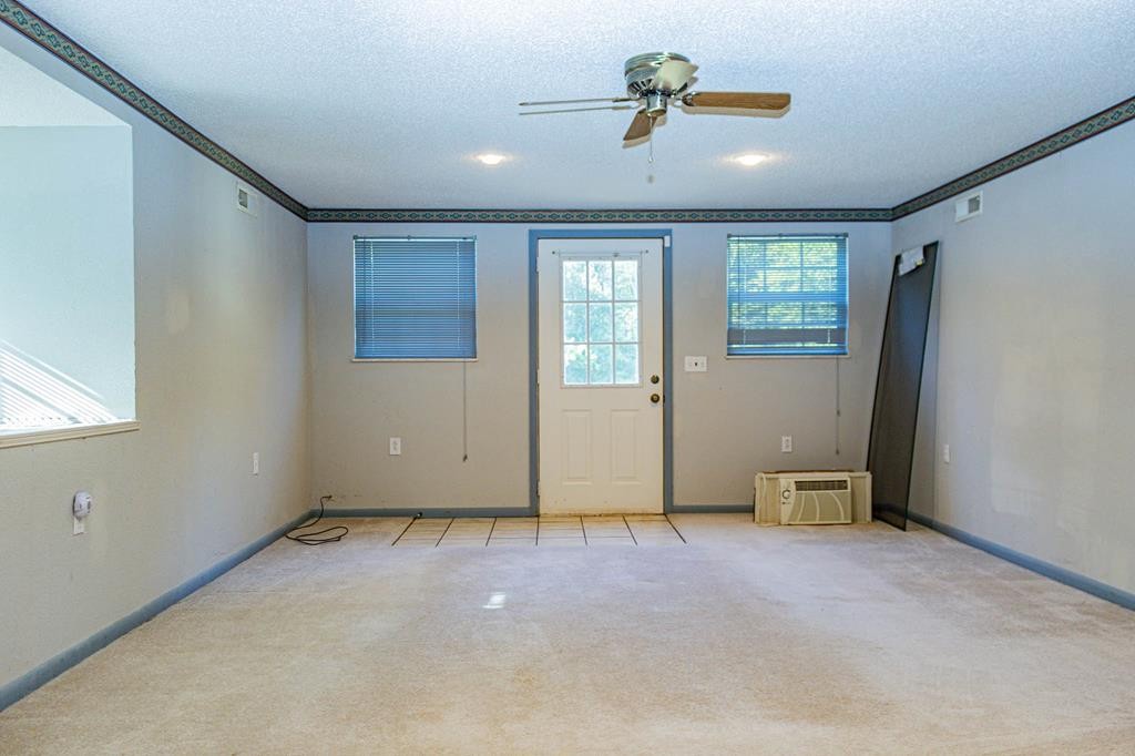 3520 Blue Springs Road Sweetwater, TN 37874 - Photo 26 of 49 an empty room with ceiling fan and windows