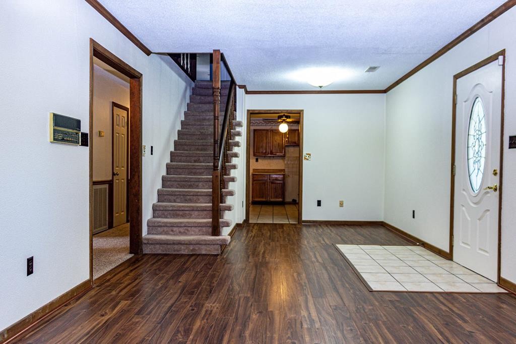 3520 Blue Springs Road Sweetwater, TN 37874 - Photo 28 of 49 a view of an empty room with wooden floor and stairs