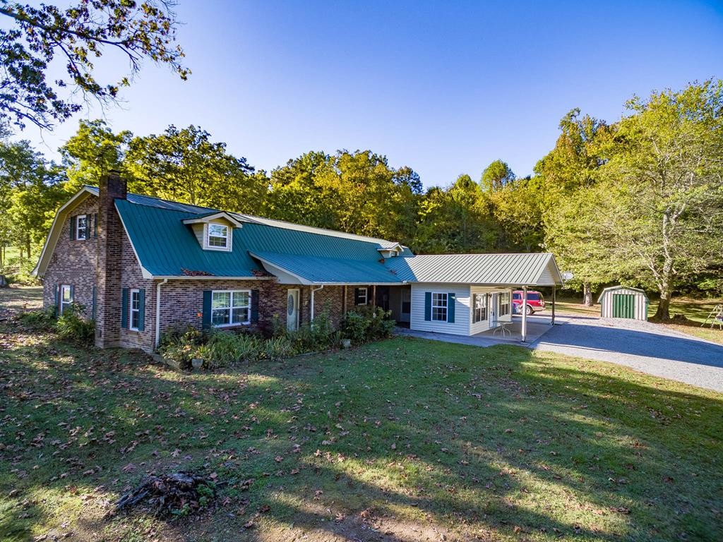 3520 Blue Springs Road Sweetwater, TN 37874 - Photo 42 of 49 a view of a house with a big yard and large trees