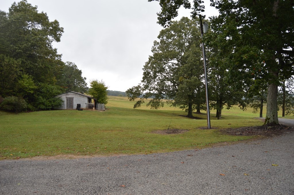 3520 Blue Springs Road Sweetwater, TN 37874 - Photo 48 of 49 a front view of a house with a big yard and a large tree