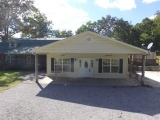 3520 Blue Springs Road Sweetwater, TN 37874 - Photo 5 of 49 a front view of a house with a yard and potted plants