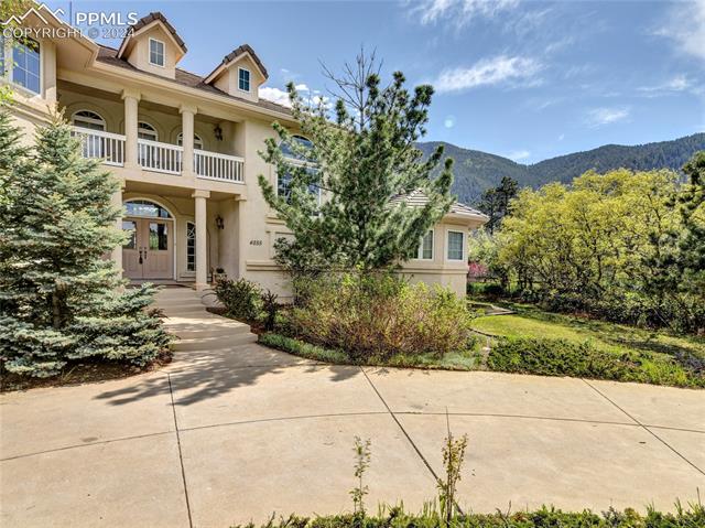 4555 Red Forest Road Monument, CO 80132 - Photo 4 of 12 View of front of home featuring a mountain view and a balcony