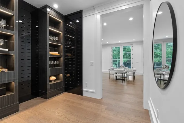 a view of an empty room with kitchen and window