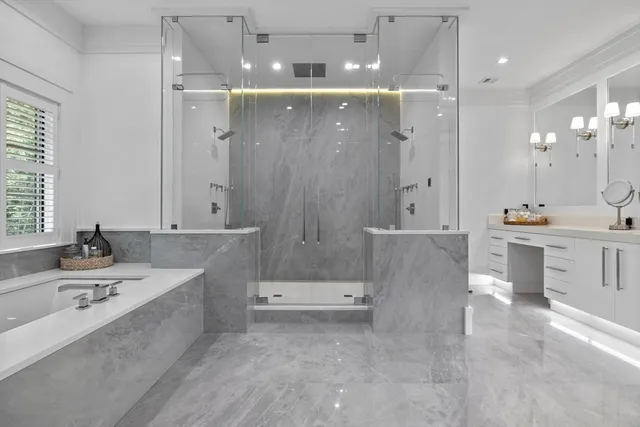 a large spacious bathroom with a large tub shower and sink