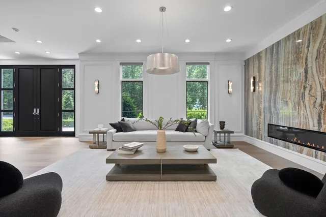 a living room with furniture and a chandelier