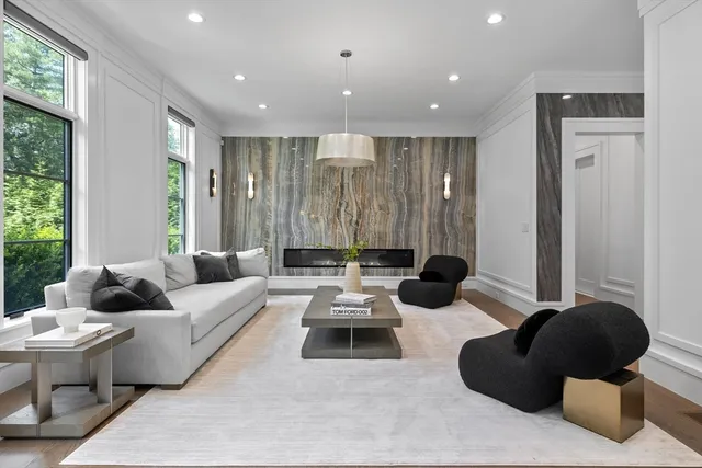 a living room with furniture and large windows