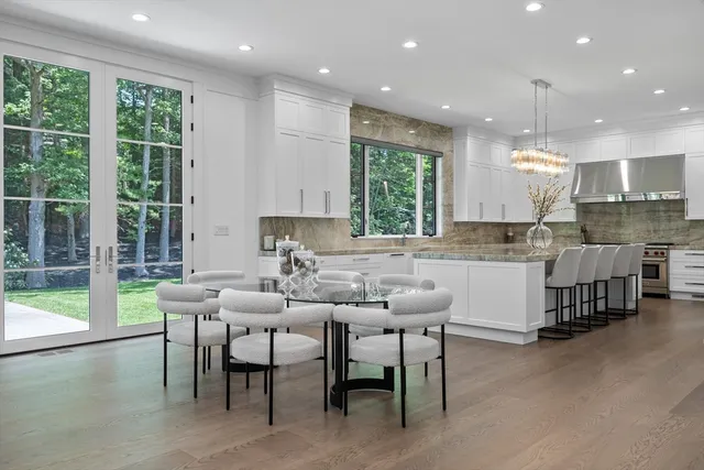 a kitchen with kitchen island granite countertop a table and chairs in it