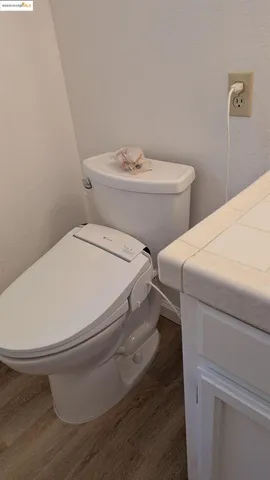 a view of a hallway with wooden floor and a chandelier