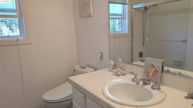 a bathroom with a sink vanity and a mirror