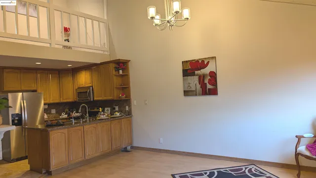 a kitchen with stainless steel appliances granite countertop a refrigerator and a stove top oven