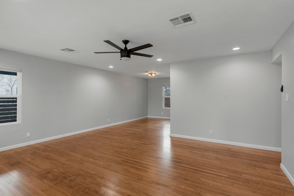 3404 Touchstone Street Austin, TX 78723 - Photo 8 of 33 Unfurnished room featuring ceiling fan, wood finished floors, and recessed lighting