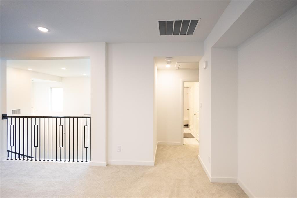 3017 Andorra Road McKinney, TX 75071 - Photo 33 of 40 Carpeted hallway with recessed lighting and a black iron railing, complemented by white walls and trim