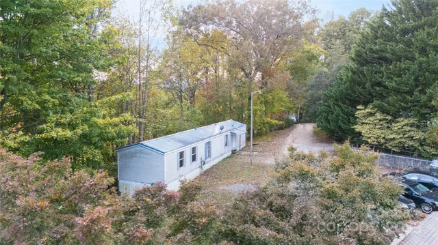 a view of a wooden house with a yard