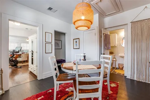 a view of a dining room with furniture and a chandelier