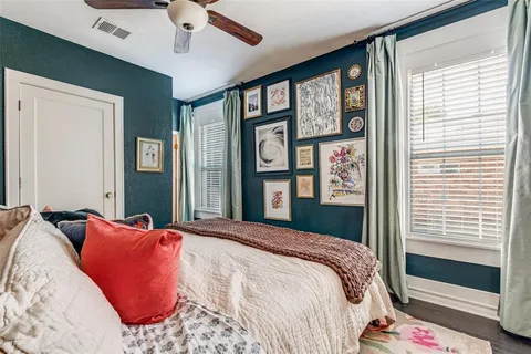 a bedroom with a large bed and a large window