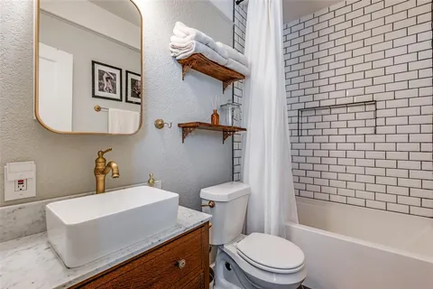 a bathroom with a toilet a sink and bathtub