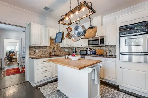 a kitchen with stainless steel appliances granite countertop a sink and cabinets