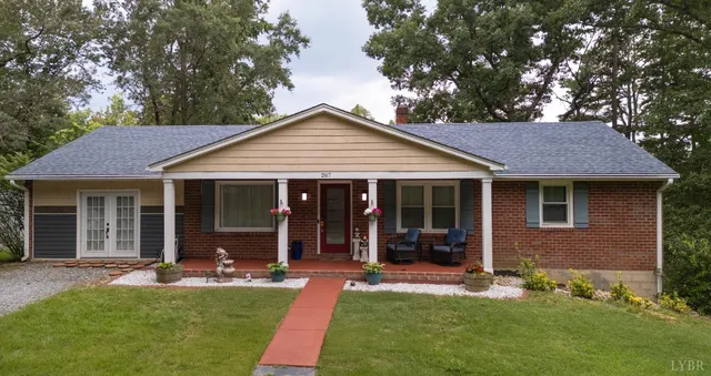 a front view of a house with a yard garden and patio