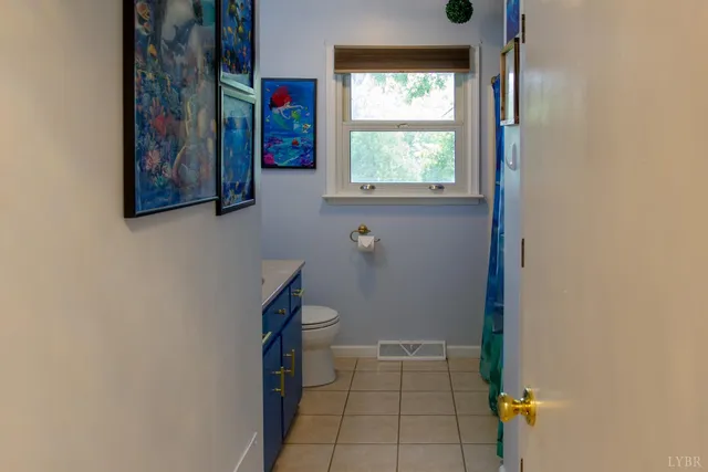 a bathroom with a sink toilet and window
