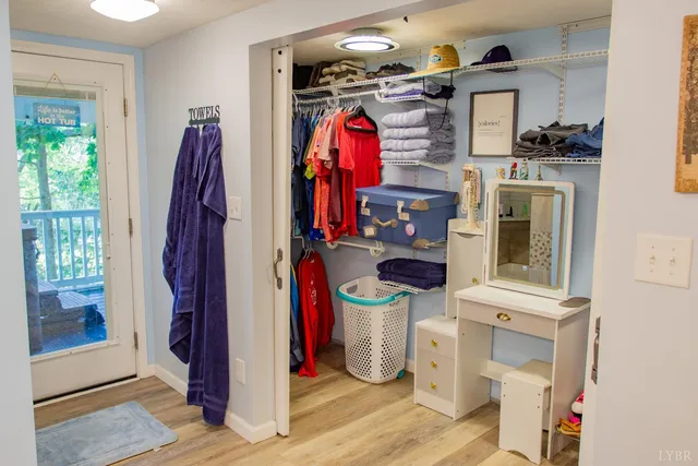 a view of walk in closet with clothes and shoes