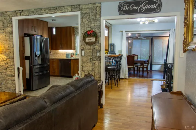 a living room with furniture and kitchen view