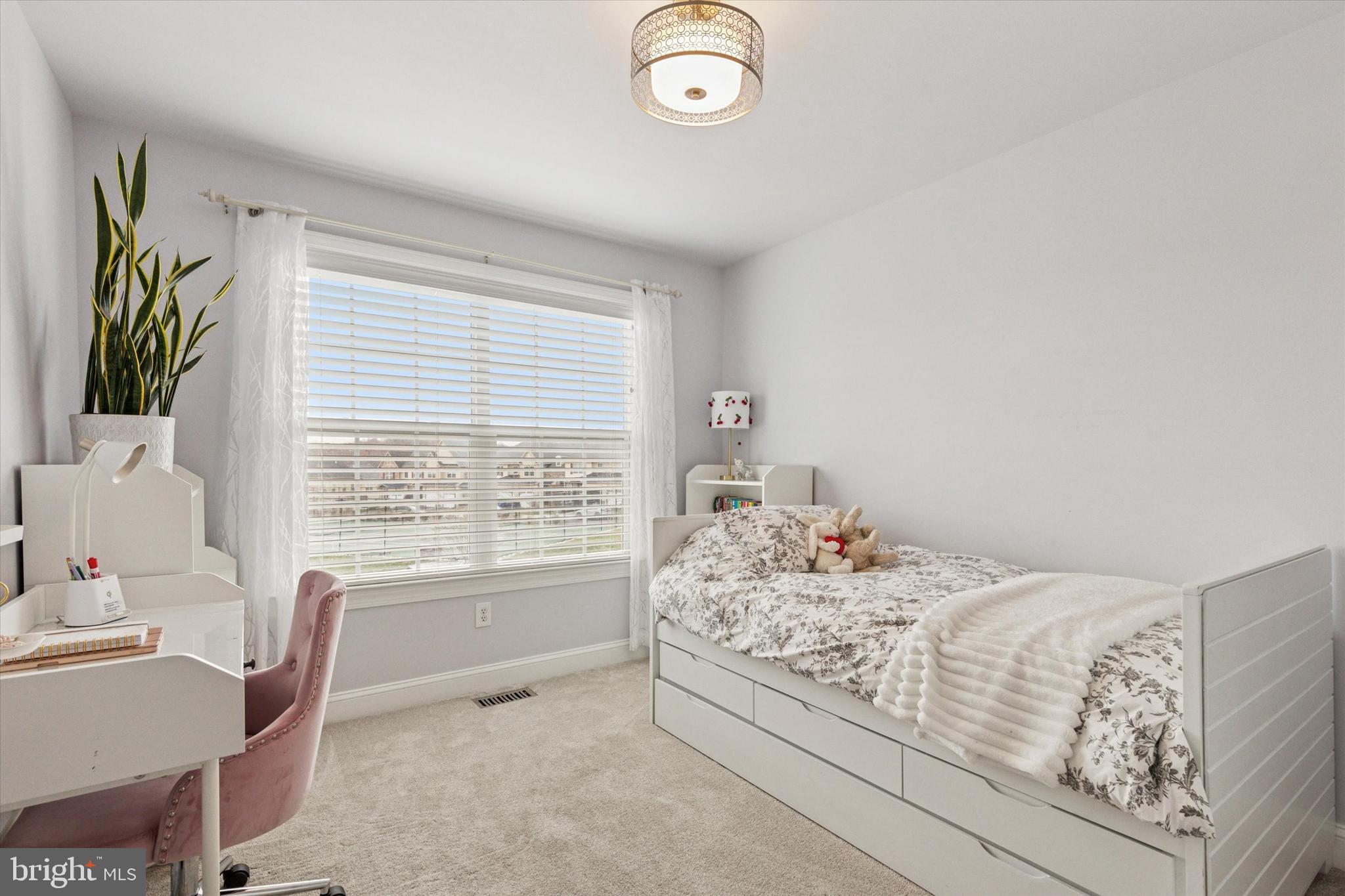 3229 Meadow View Circle, Unit 157 Furlong, PA 18925 - Photo 19 of 28 a bed sitting in a bedroom next to a window