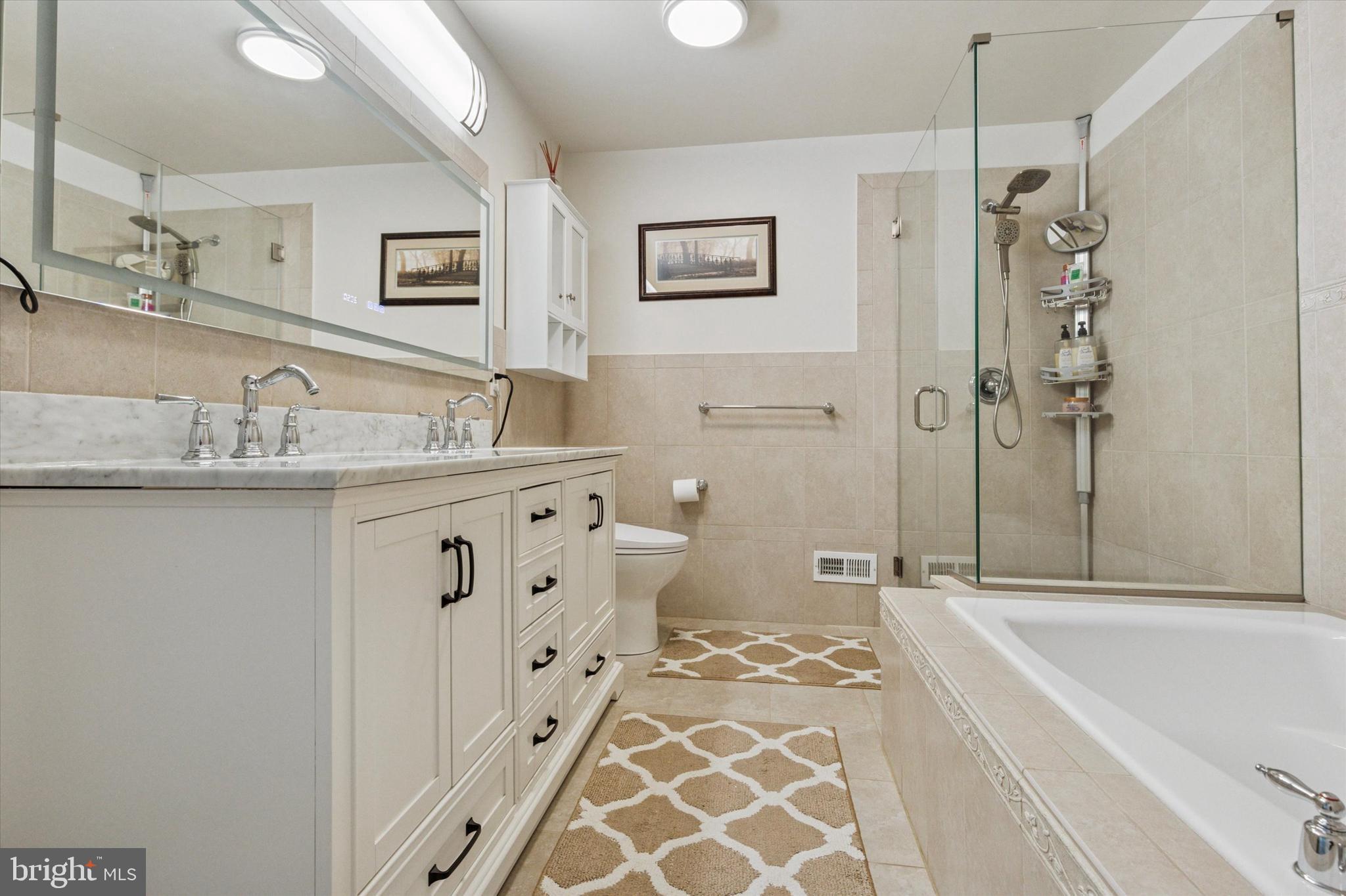 3229 Meadow View Circle, Unit 157 Furlong, PA 18925 - Photo 23 of 28 a bathroom with a bathtub sink and mirror