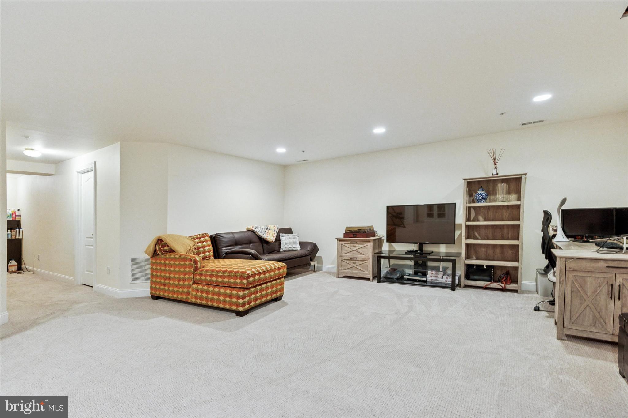 3229 Meadow View Circle, Unit 157 Furlong, PA 18925 - Photo 24 of 28 a living room with furniture and a flat screen tv