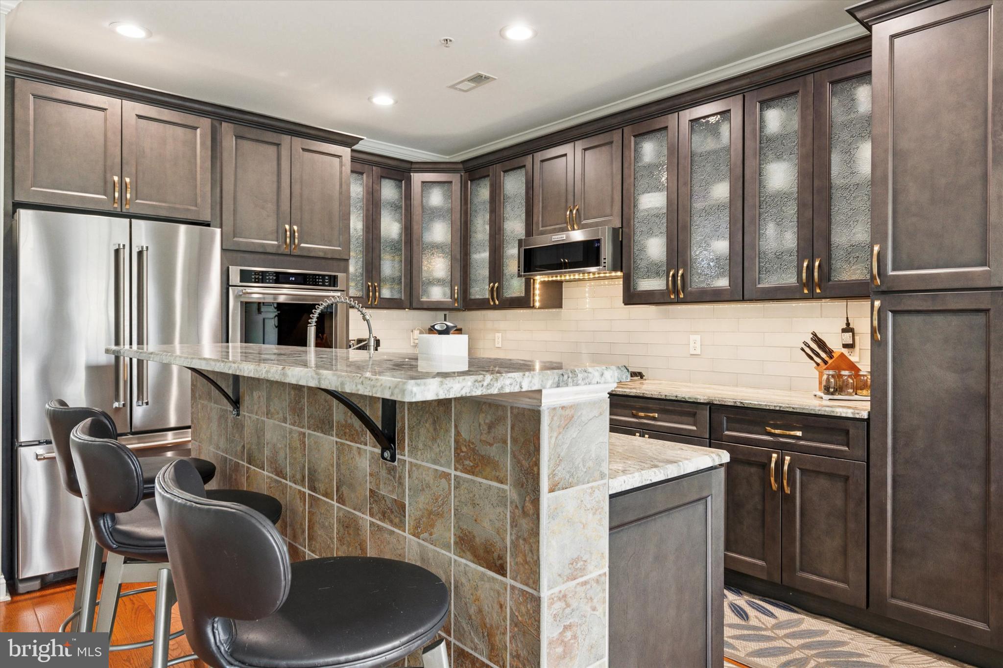 3229 Meadow View Circle, Unit 157 Furlong, PA 18925 - Photo 9 of 28 a kitchen with stainless steel appliances granite countertop a stove a sink a microwave a refrigerator and cabinets