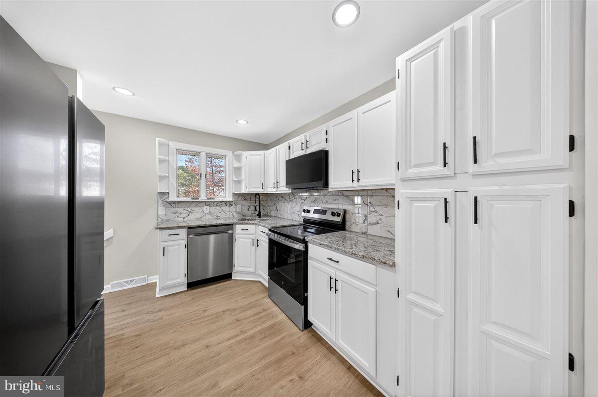 24 Vansant Road Newark, DE 19711 - Photo 12 of 44 a kitchen with stainless steel appliances granite countertop a refrigerator sink and white cabinets