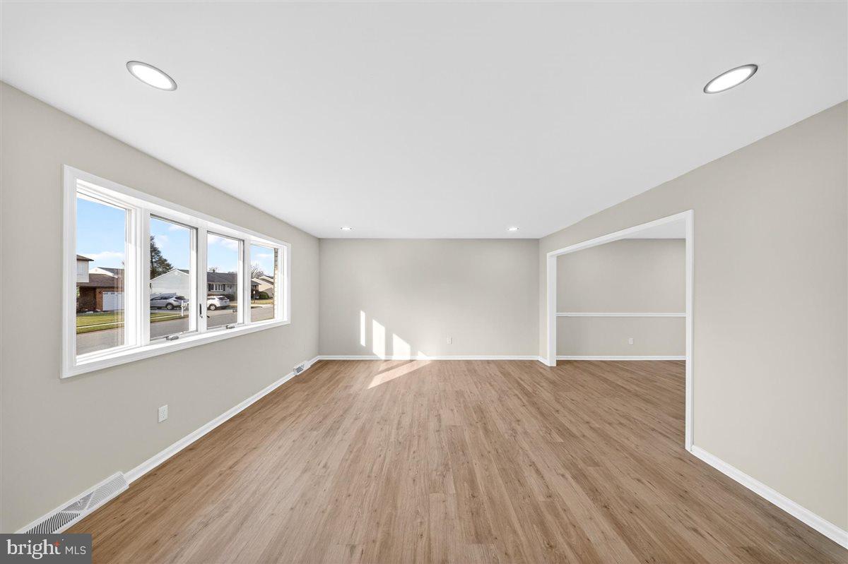 24 Vansant Road Newark, DE 19711 - Photo 6 of 44 an empty room with wooden floor and windows