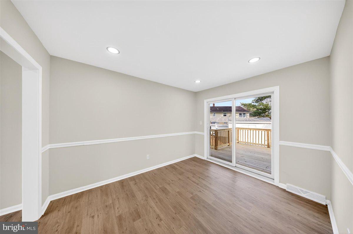 24 Vansant Road Newark, DE 19711 - Photo 10 of 44 an empty room with wooden floor and windows