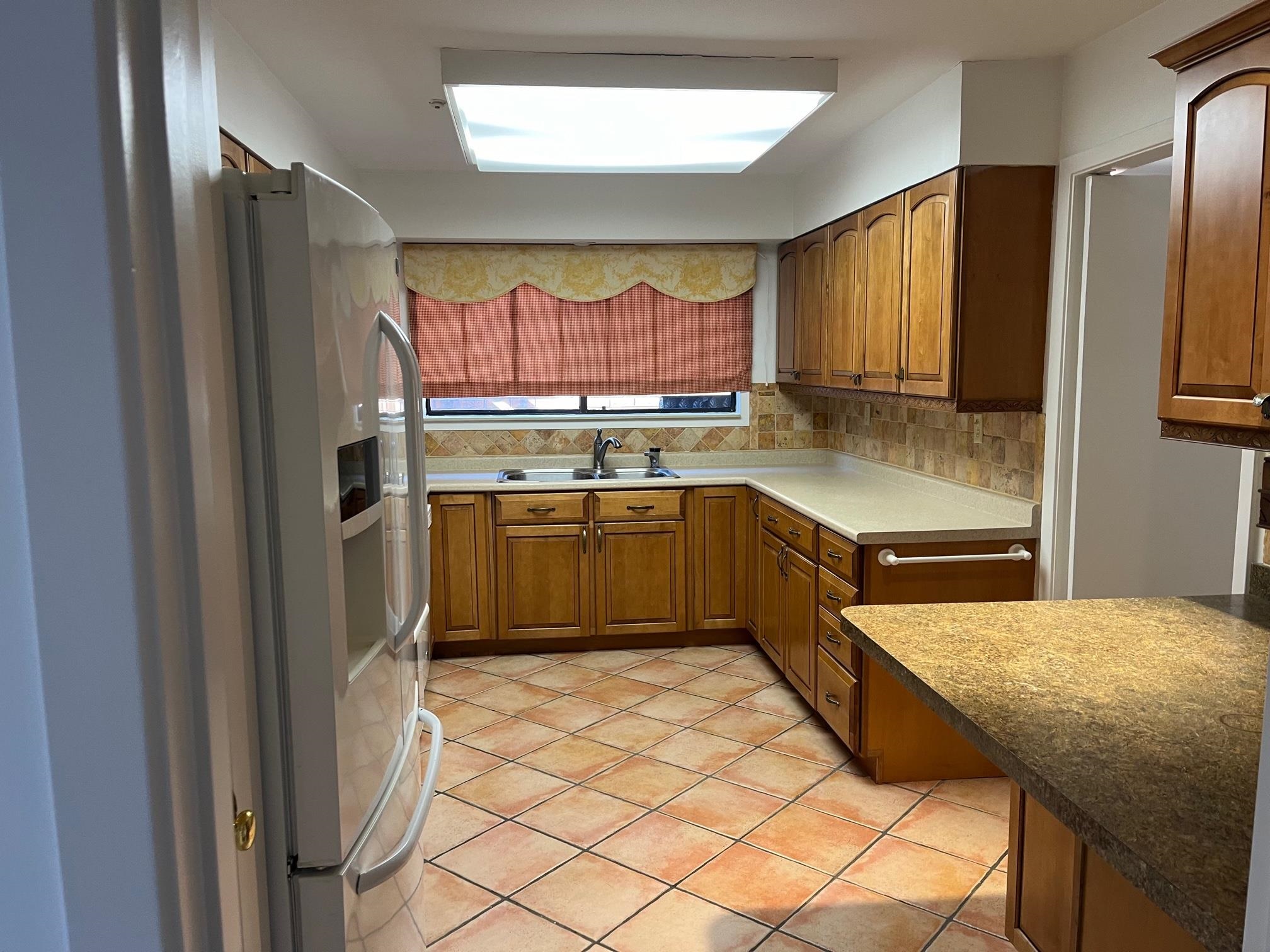 6536 Cherryhill Ridge Memphis, TN 38120 - Photo 5 of 8 a kitchen with a sink a refrigerator and cabinets