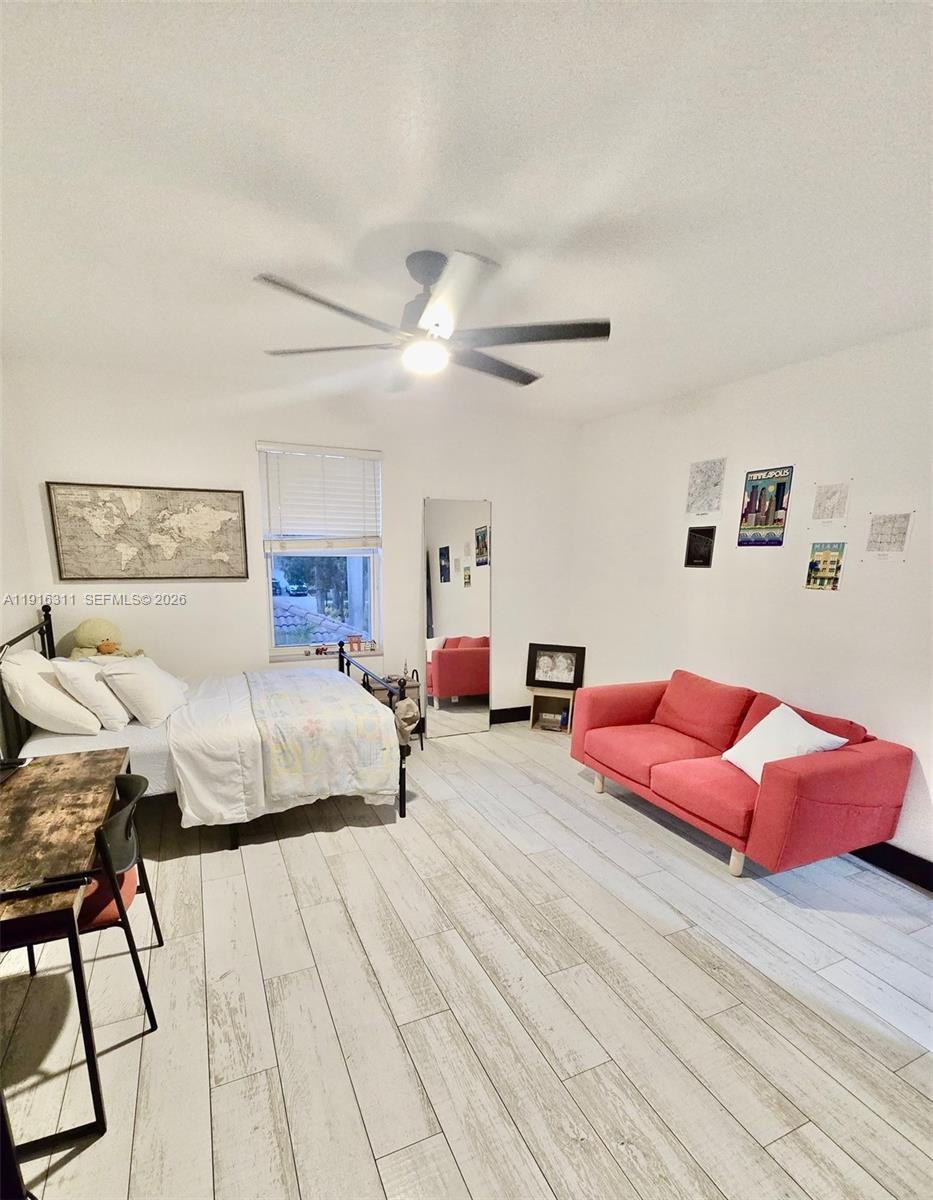 2019 Harbor View Circle Weston, FL 33327 - Photo 18 of 29 a spacious bedroom with a bed and lamp