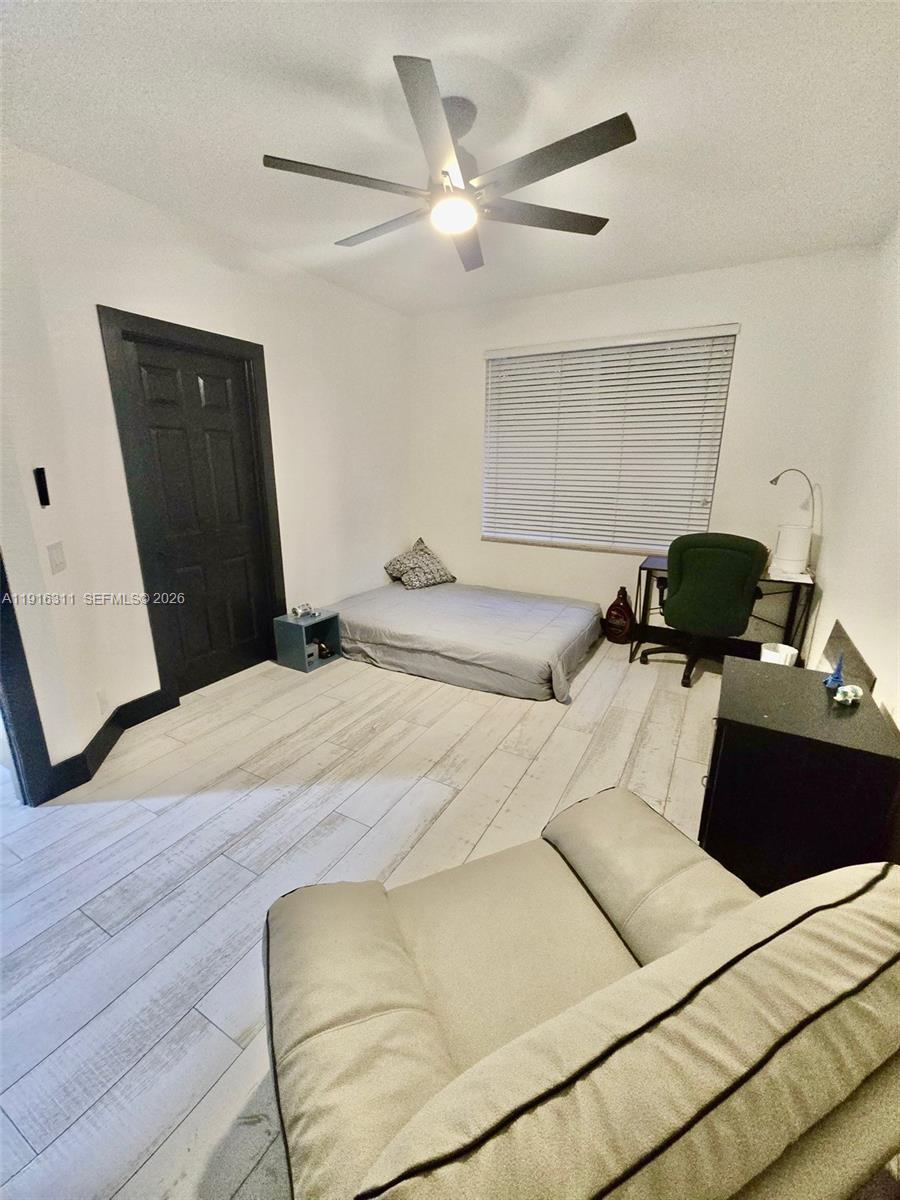 2019 Harbor View Circle Weston, FL 33327 - Photo 20 of 29 a bedroom with a bed and wooden floor