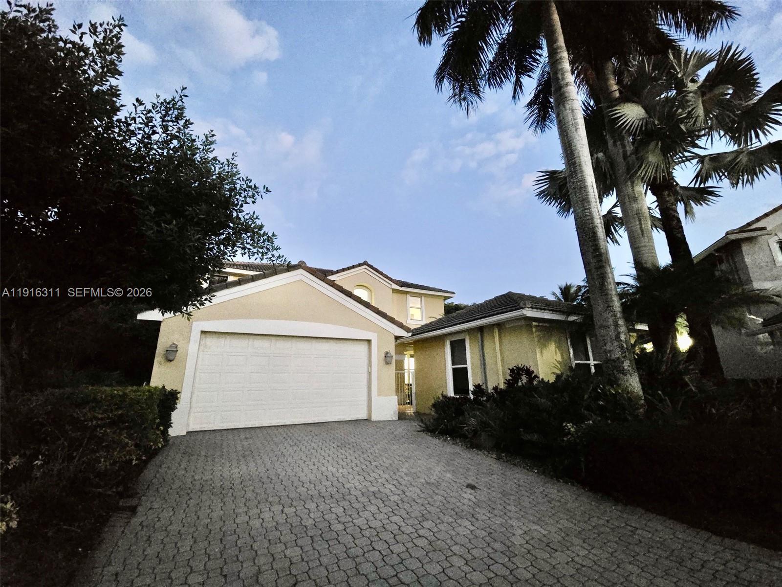 2019 Harbor View Circle Weston, FL 33327 - Photo 21 of 29 a front view of a house with a yard and garage