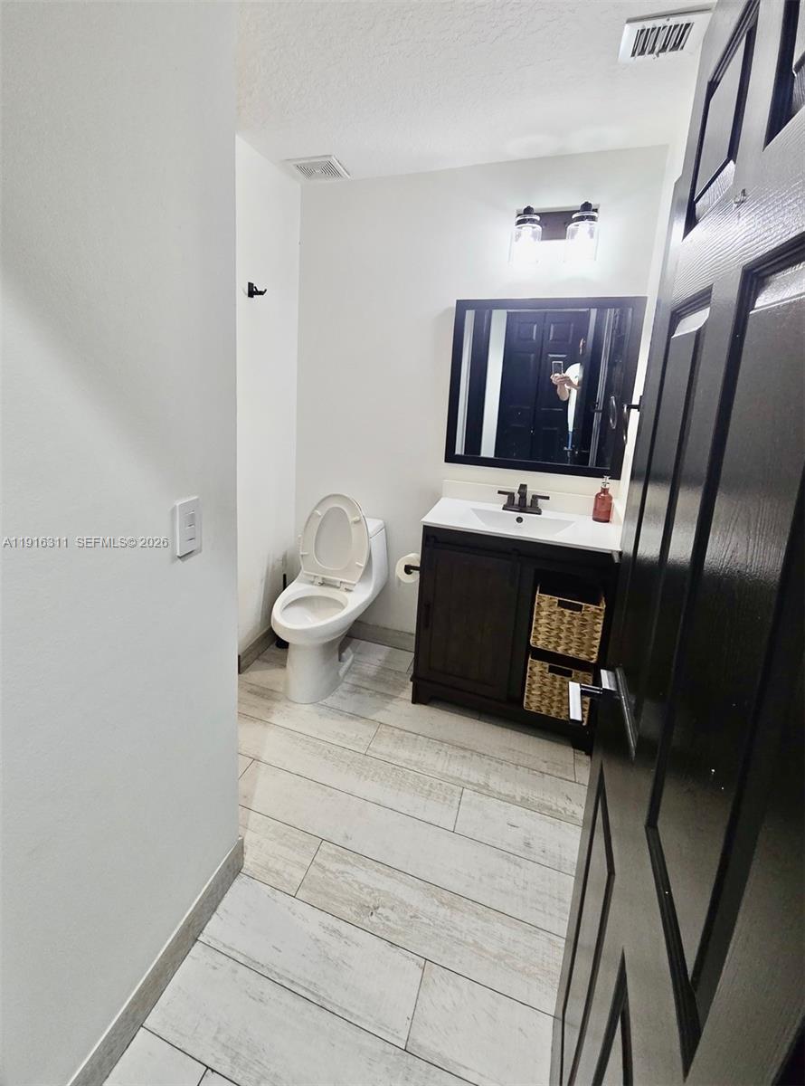 2019 Harbor View Circle Weston, FL 33327 - Photo 22 of 29 a living room with furniture and a mirror